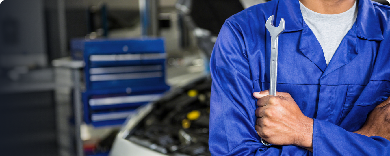 Mechanic holding a wrench in a service shop